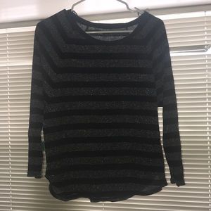 A long sleeve shirt with silver and black stripes